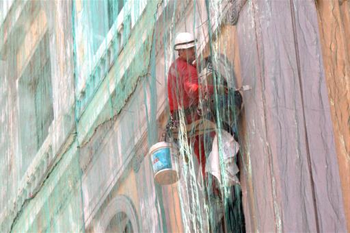 Trabajador pintando una pared