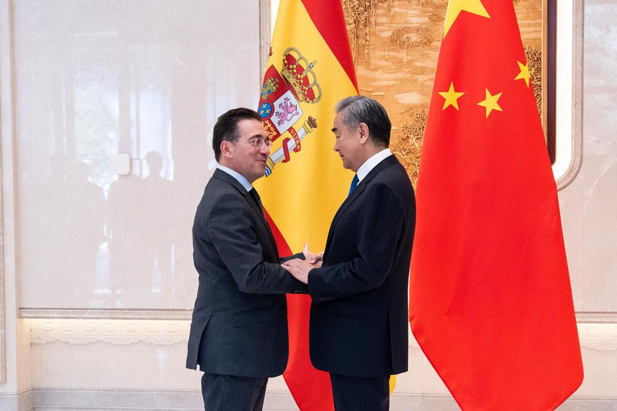 El ministro de Asuntos Exteriores, Unión Europea y Cooperación, José Manuel Albares, y su homólogo chino, Wang Yi, se saludan.